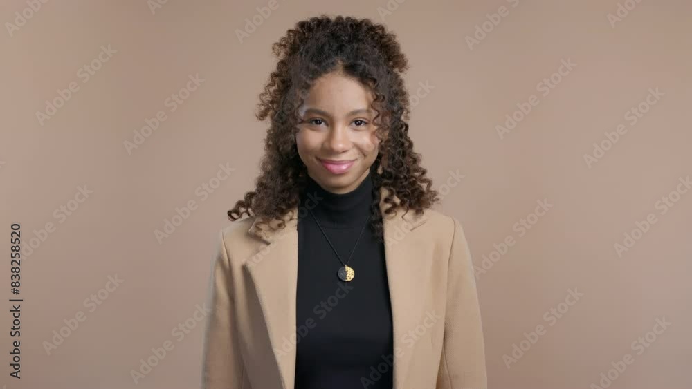 Gossiper african woman with finger on lips - shh, secret, silence, beige studio Gossiper african woman with finger on lips - shh, secret, silence, beige studio