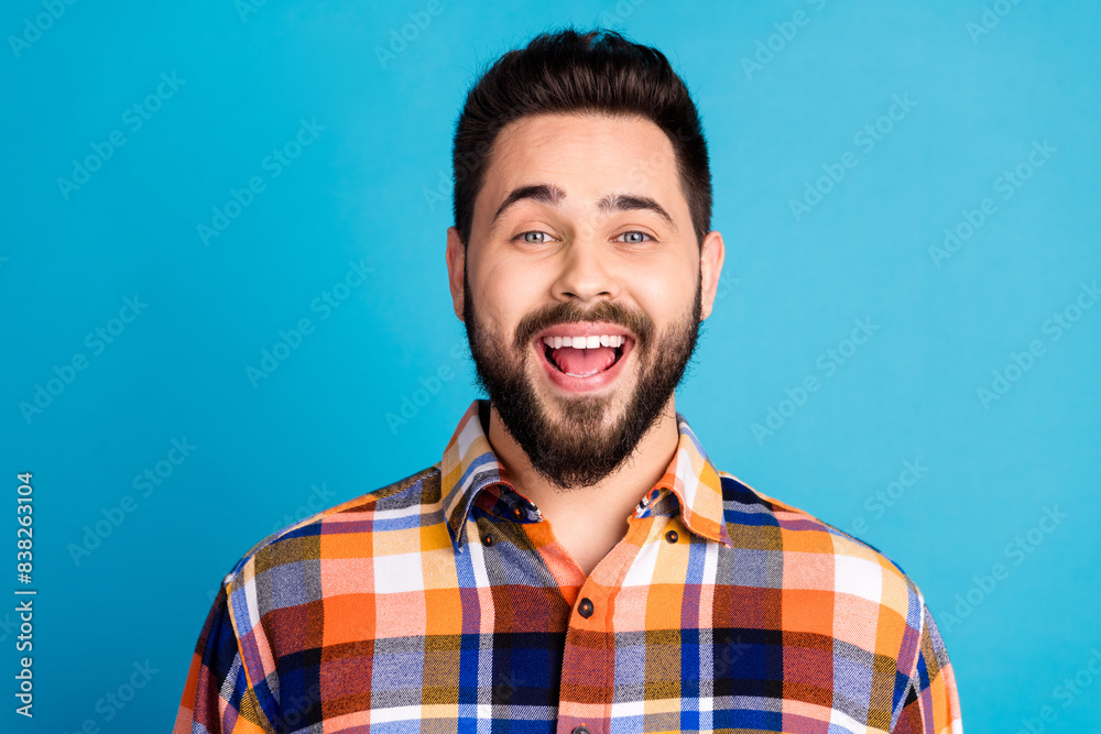 Portrait of nice young man open mouth wear shirt isolated on blue color background Portrait of nice young man open mouth wear shirt isolated on blue color background
