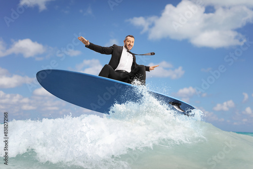 Canvas Print Businessman surfing on a surfboard