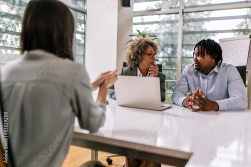 Human resource team talking to a candidate during a job interview in the office.