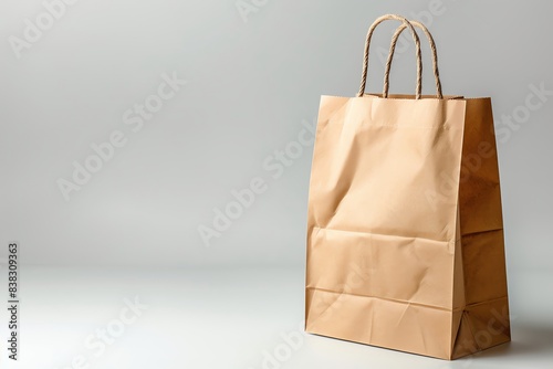 Eco-friendly brown paper bag with handles on a plain background, perfect for shopping or carrying items sustainably.
