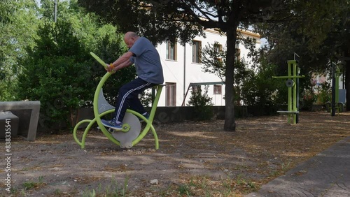 elderly outdoor sports. elderly people doing sports in an urban area equipped for sports, such as bicycles. keep seniors fit.