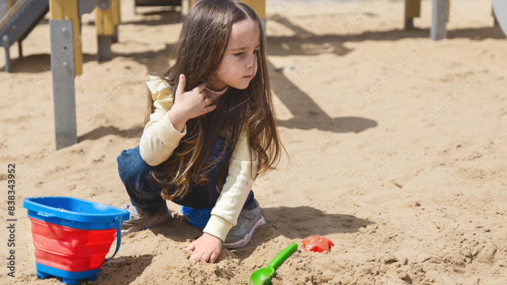 Сute little girl on playground in sandpit. Child playing with sand molds and making mud pies. Outdoor creative activities for kids Сute little girl on playground in sandpit. Child playing with sand molds and making mud pies. Outdoor creative activities for kids