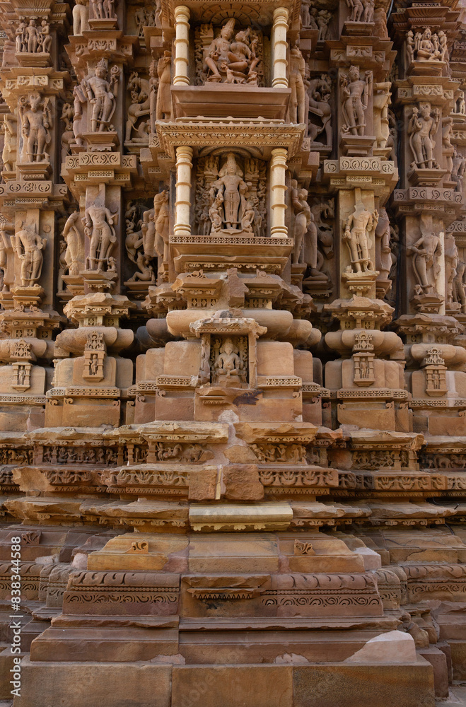 Sculptures and intricate designs carved on the wall of Chitragupta Temple in the Khajuraho temple complex, India