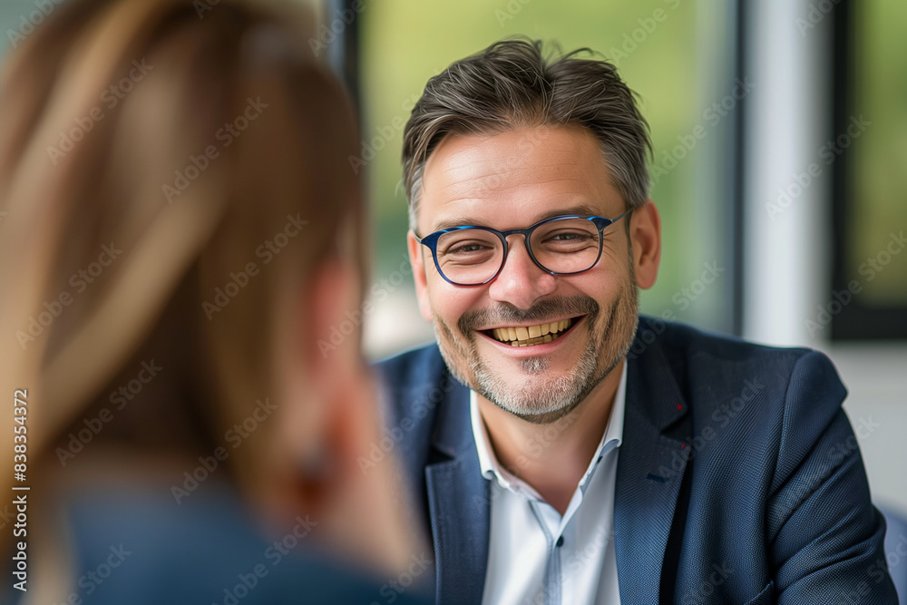 smiling business manager having an interview with a woman in the office smiling business manager having an interview with a woman in the office