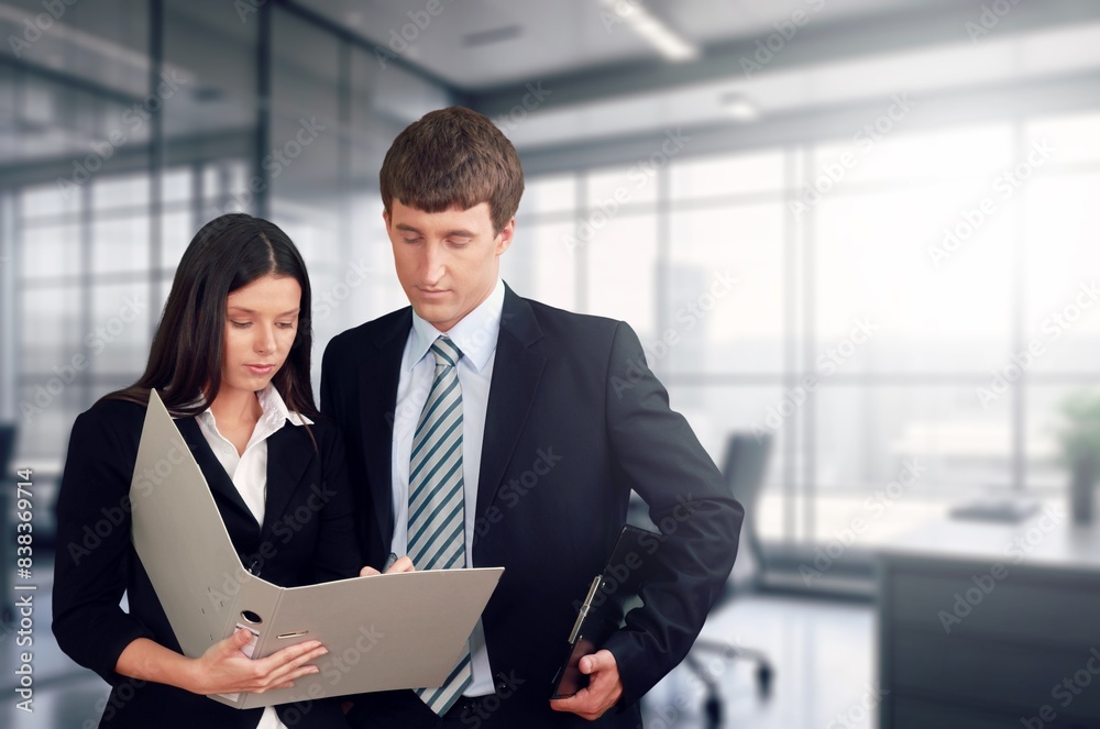 Happy young professional businessman and woman discussing project Happy young professional businessman and woman discussing project