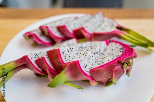 Chef cuts and peels dragon fruit on the cutting board