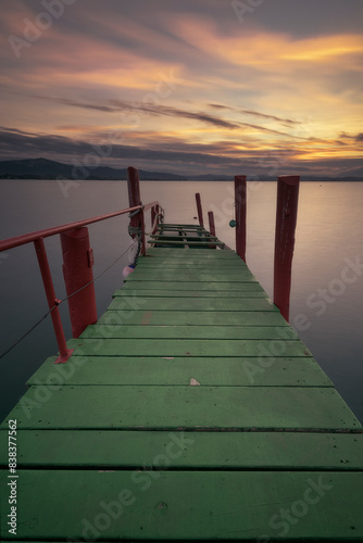 Old wooden walkway used as a pier painted in striking colors  green and red  in Puntal de Somo  Santander