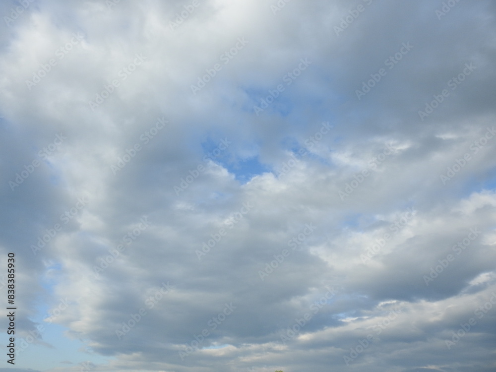Cumulus clouds within a blue sky over Northampton County, Pennsylvania. Cloudscape. Cumulus clouds within a blue sky over Northampton County, Pennsylvania. Cloudscape.