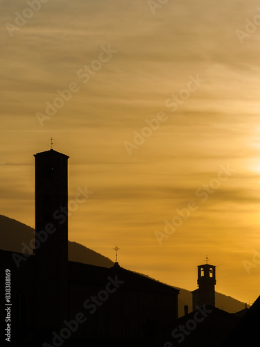 Lucca old skyline at sunset with medieval towers silhouette and golden clouds