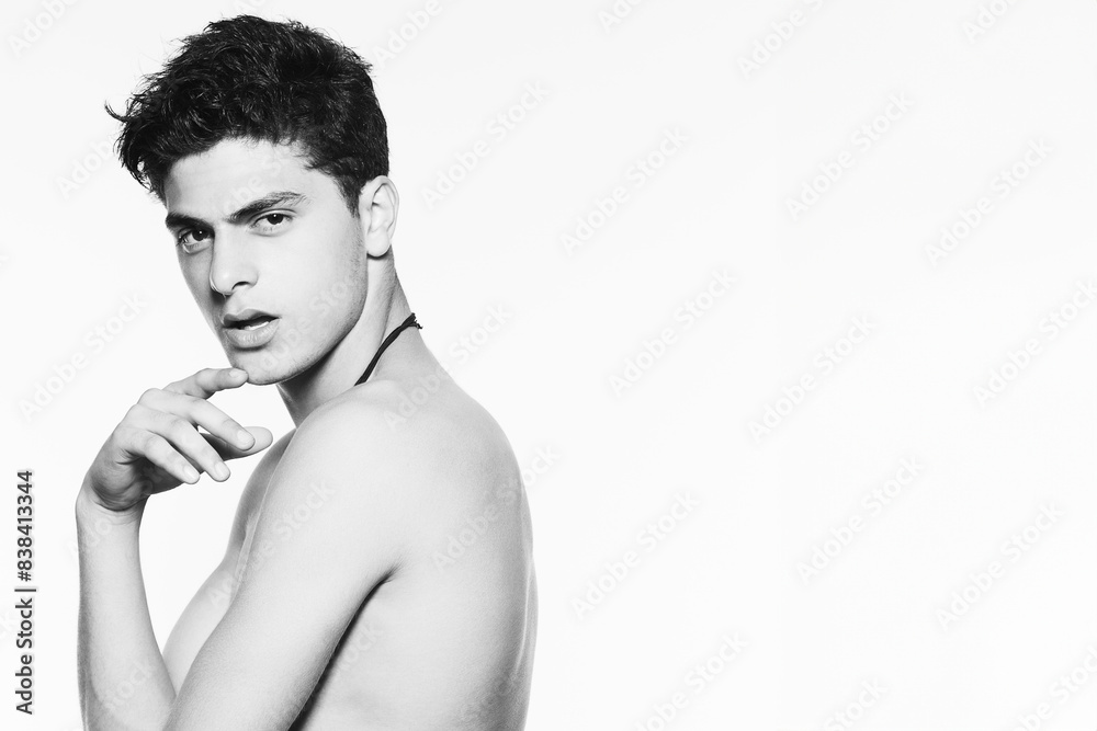 Fototapeta premium Male beauty concept. Handsome muscular male model with perfect muscular body isolated on white background. Close up. Copy-space. Banner style. Fashion studio portrait