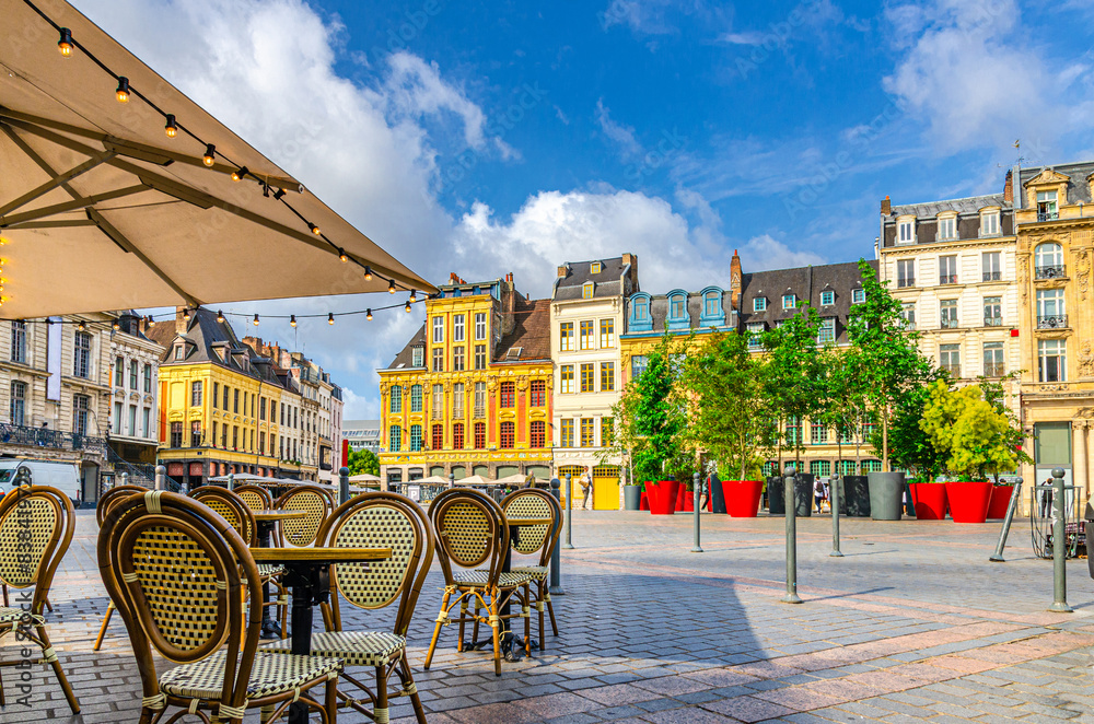 La Grand Place square in Lille city center, Flemish mannerist architecture style buildings, trees in pots, tables and chairs of street restaurant, French Flanders, Nord department, Northern France