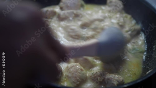Creamy Chicken Cooking in Skillet Closeup with homemade sauce for a succulent gourmet dish photo