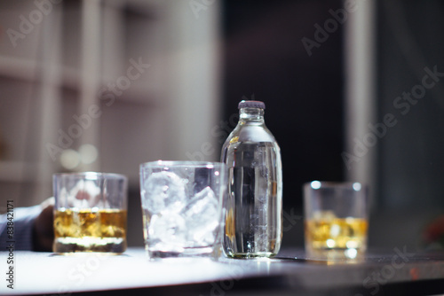 glass of alcohol is left on table after drinking with friends in office after work so that alcohol helps relax mind. Concept of       drinking alcohol in moderation and campaigning against drunk driving.