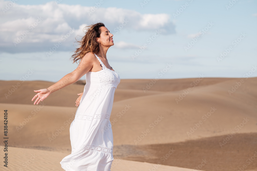 Middle-aged woman taking a breath in a heavenly place and breathing. Concept: Rest, relaxation Middle-aged woman taking a breath in a heavenly place and breathing. Concept: Rest, relaxation