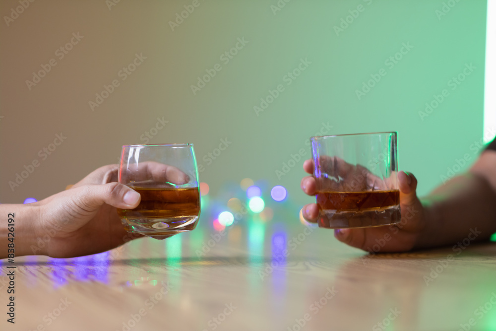 A group of businessmen held brandy glasses together to cheers glasses of brandy after concluding negotiations on business ventures and reaching a satisfactory agreement for joint business profits. A group of businessmen held brandy glasses together to cheers glasses of brandy after concluding negotiations on business ventures and reaching a satisfactory agreement for joint business profits.