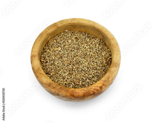 anise seeds seasoning in a wooden bowl isolated on white. photo