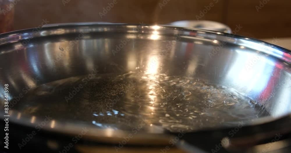 Pot of boiling water over black background. Bubbles of boiling water. Slow motion shot Pot of boiling water over black background. Bubbles of boiling water. Slow motion shot