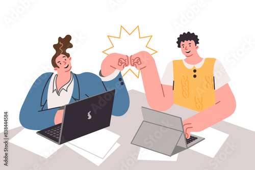 Successful collaboration of men students working sitting at desk, punching after end of business day