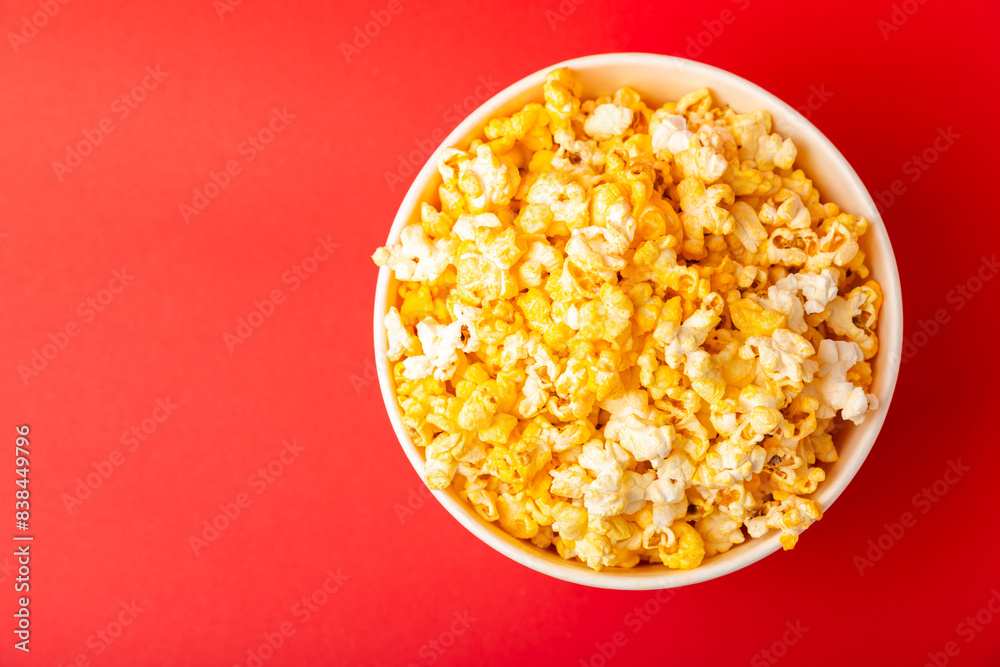 Popcorn box. Red and white striped buckets of popcorn on a red background. Cinema and entertainment concept. Movie night with popcorn. Cheesy popcorn. Delicious appetizer, snack. Place for text. Popcorn box. Red and white striped buckets of popcorn on a red background. Cinema and entertainment concept. Movie night with popcorn. Cheesy popcorn. Delicious appetizer, snack. Place for text.