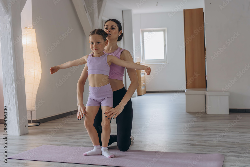Baby ballet studio. Little ballerina with a coach in dance class. Ballet trainer for children Baby ballet studio. Little ballerina with a coach in dance class. Ballet trainer for children