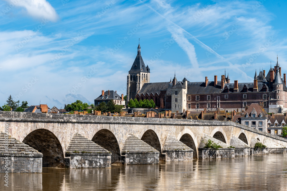 Obraz premium Views of old part of town of Gien is on the Loire river, in Loiret department, France, bridge and castle