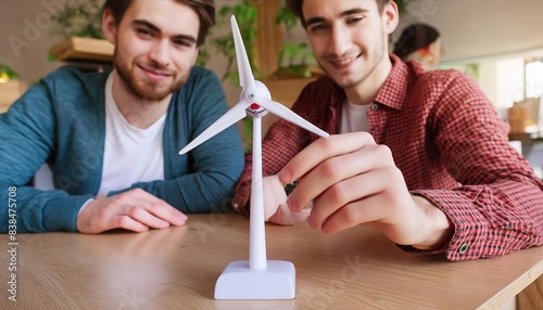 young creative team with small wind turbine on table in offiece photo