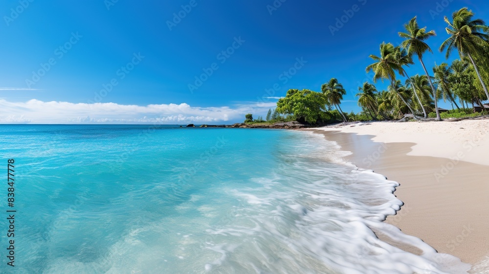 Serene beach with turquoise waters and white sands, palm trees swaying in the breeze  