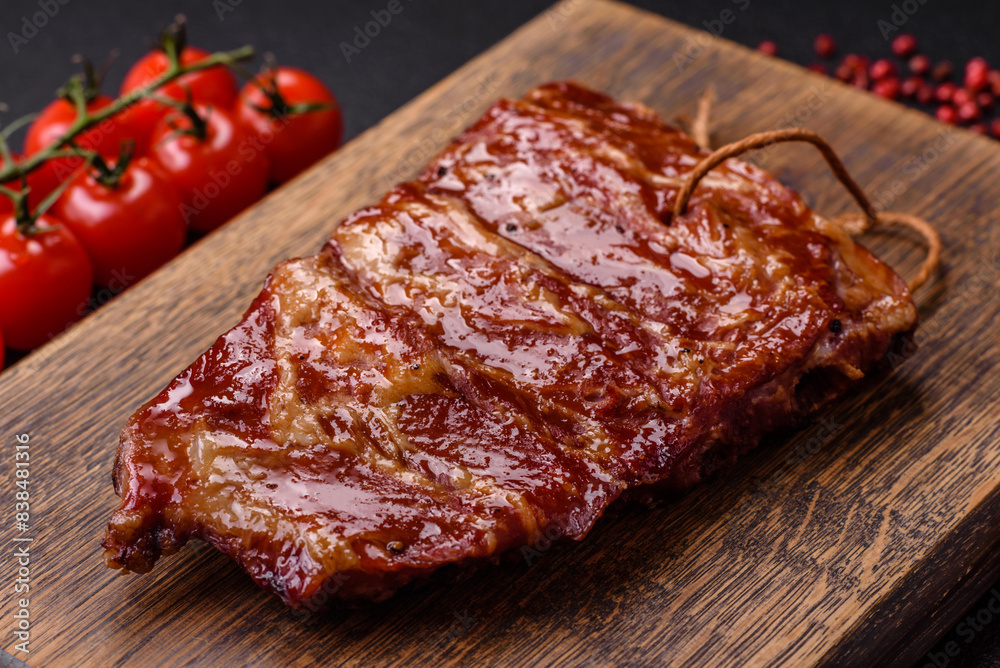 Delicious juicy grilled ribs baked on the grill with salt, spices and herbs Delicious juicy grilled ribs baked on the grill with salt, spices and herbs