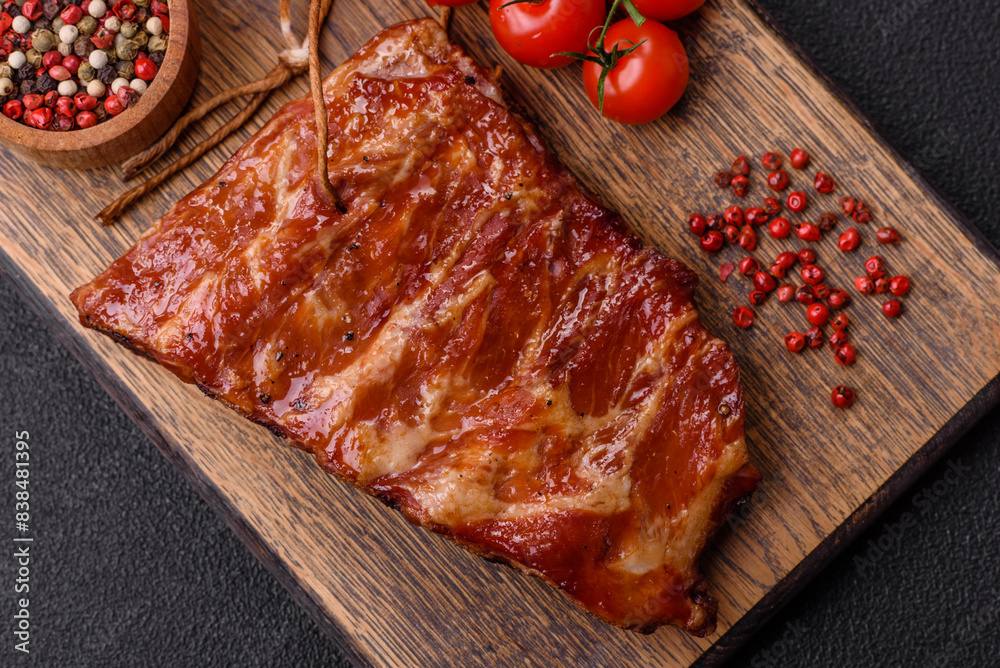 Delicious juicy grilled ribs baked on the grill with salt, spices and herbs Delicious juicy grilled ribs baked on the grill with salt, spices and herbs