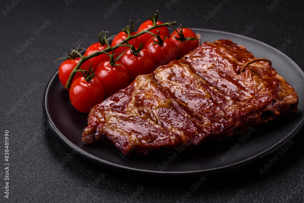 Delicious juicy grilled ribs baked on the grill with salt, spices and herbs Delicious juicy grilled ribs baked on the grill with salt, spices and herbs