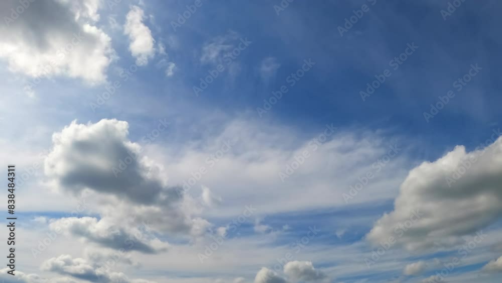 Clouds transform in the atmosphere. Little white clouds grow into a dramatic cloudscape. Low angle view. Timelapse. Clouds transform in the atmosphere. Little white clouds grow into a dramatic cloudscape. Low angle view. Timelapse.