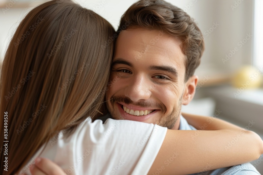 Man smiling, embracing woman in white shirt Man smiling, embracing woman in white shirt