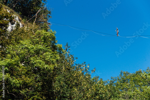 un funambule dans la nature. Funambule en extérieur naturel. Acrobate sur un fil en hauteur. Funambule sur une corde tendue. Funambulisme dehors.. Equilibre photo