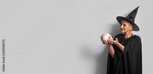 Mature witch holding human ...