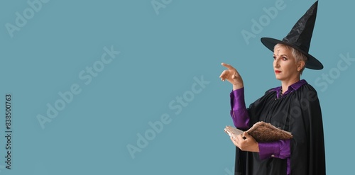 Mature witch holding spell ...