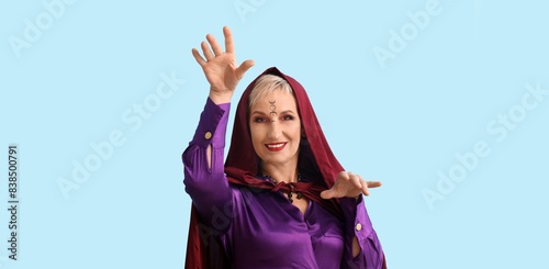 Mature witch on light blue ...