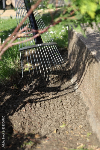 Laying an anti-weed mat in the garden together with paving stones and decorative pebbles.