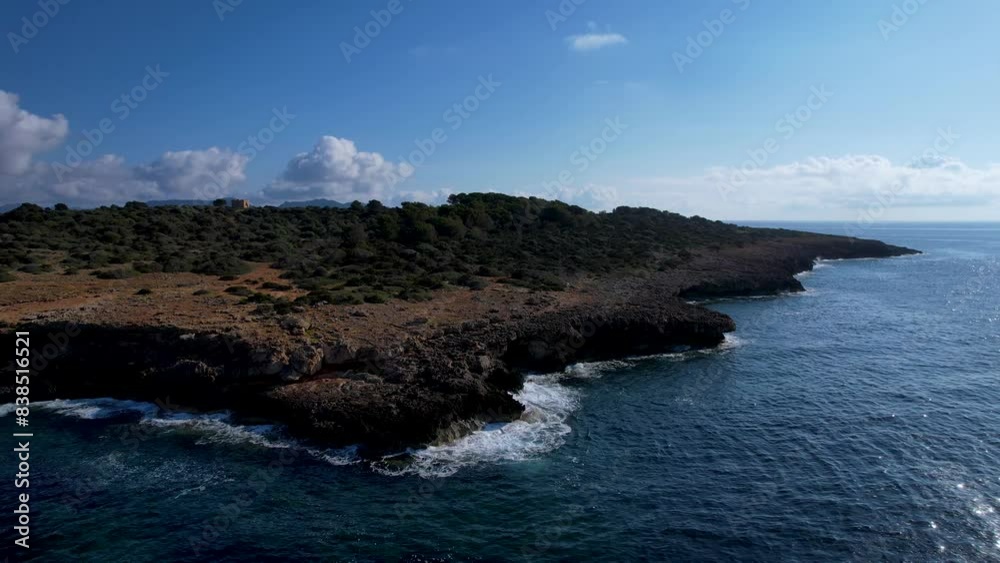 4K Aerial Drone video of the rocky coast with crystal clear water in Mallorca with rough waves crashing against the cliffs on a sunny summer day 4K Aerial Drone video of the rocky coast with crystal clear water in Mallorca with rough waves crashing against the cliffs on a sunny summer day