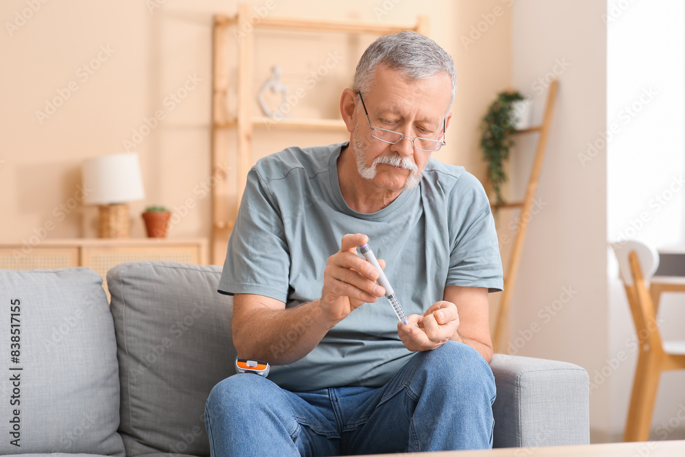 Senior man giving himself insulin injection at home. Diabetes concept Senior man giving himself insulin injection at home. Diabetes concept