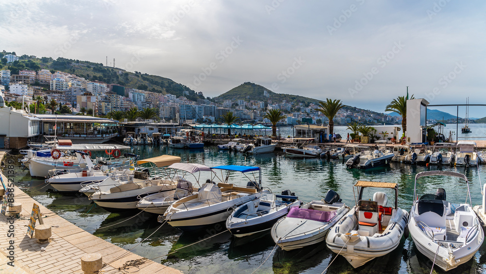 Obraz premium A panorama view of boats moored in the marina at Sarande, Albania in the morning in summertime