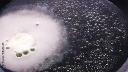 effervescent tablet on a black surface, video