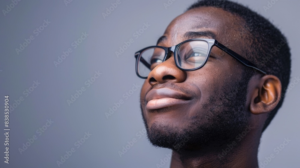Guy Wearing Glasses. African American man with a Happy Smile in Eyeglasses on Gray Background Guy Wearing Glasses. African American man with a Happy Smile in Eyeglasses on Gray Background