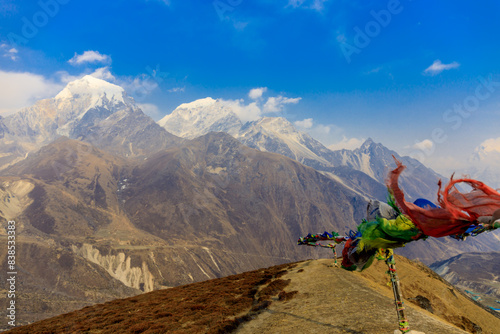 Colorful Nepali and Tibetan prayer flags fluttering in the majestic mountains of Nepal. Symbolizing peace, compassion, and blessings, flags adorn the serene landscape of Himalaya mountains photo