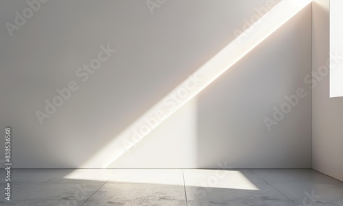 Abstract white background with a spotlight beam on the white wall of an empty room interior for product presentation in a minimal style. 