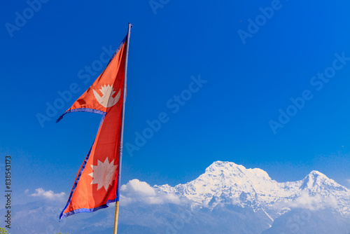 Colorful Nepali and Tibetan prayer flags fluttering in the majestic mountains of Nepal. Symbolizing peace, compassion, and blessings, flags adorn the serene landscape of Himalaya mountains