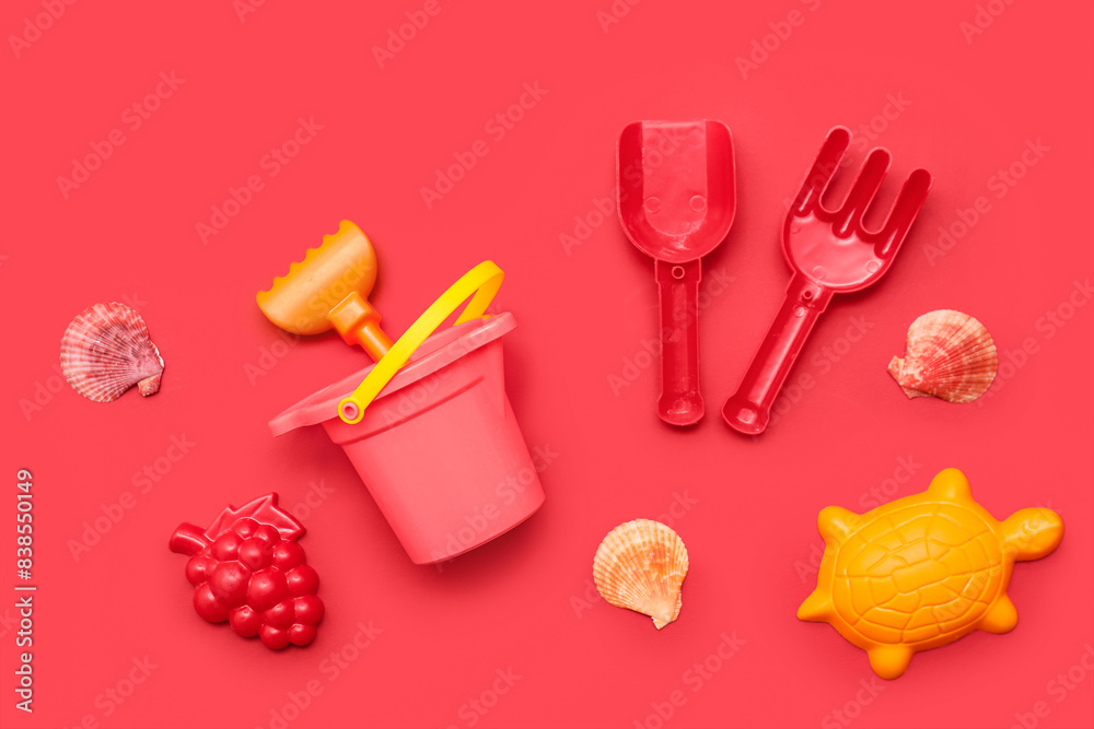 Set of beach accessories for children on red background. Top view Set of beach accessories for children on red background. Top view