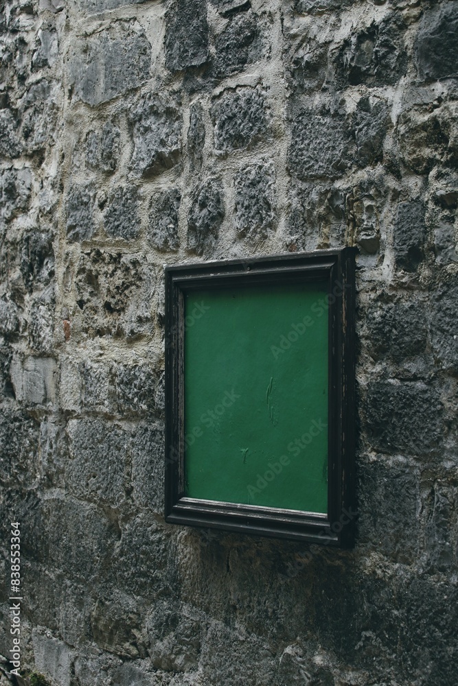 Green painting on the ancient stone wall in kotor Green painting on the ancient stone wall in kotor