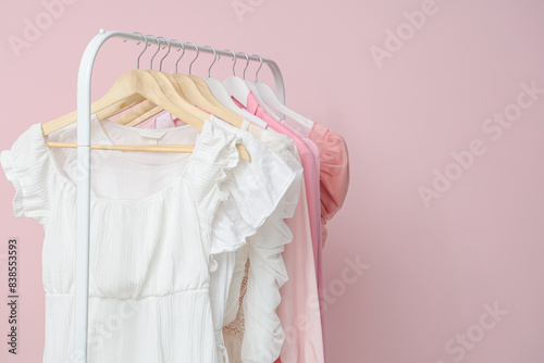 Wallpaper Mural Pink clothes on hanger against color wall Torontodigital.ca