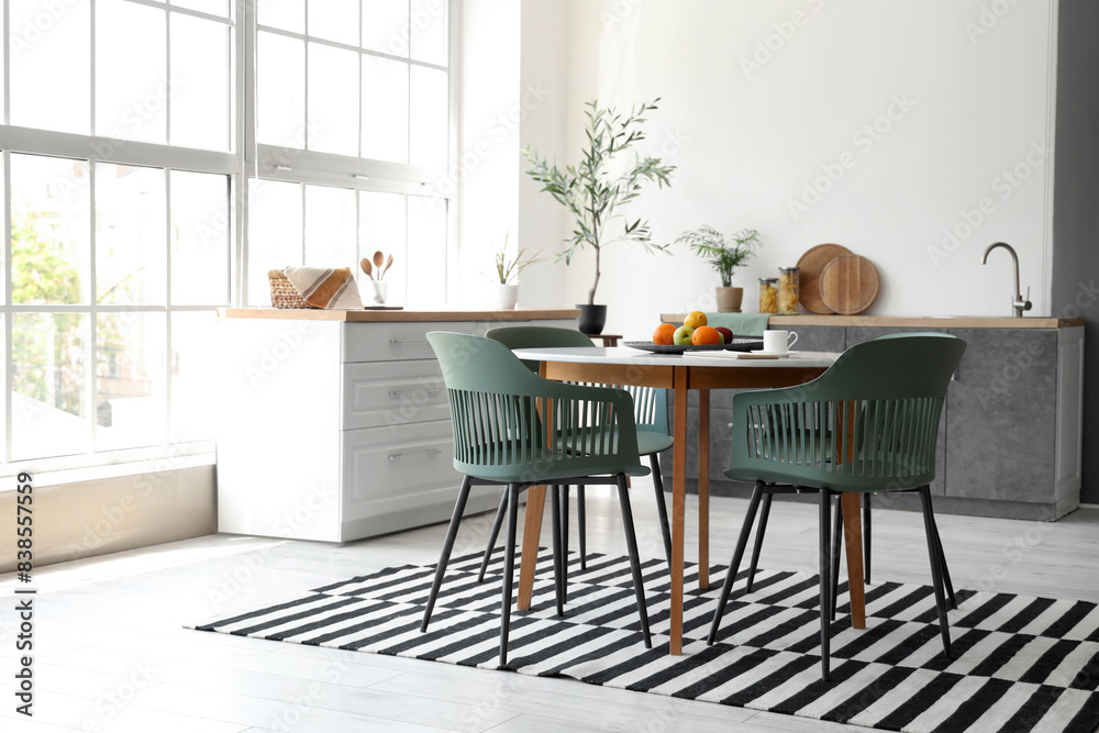 Interior of stylish room with dining table and counters Interior of stylish room with dining table and counters